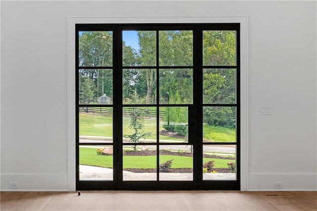 10155 Cedar Ridge Dr, Milton, GA 30004 - doorway with healthy amount of natural light, baseboards, and light wood-style flooring