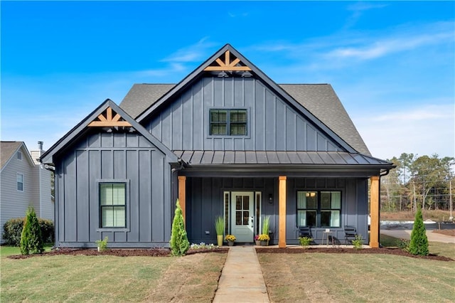 modern farmhouse style home featuring a front lawn and a porch