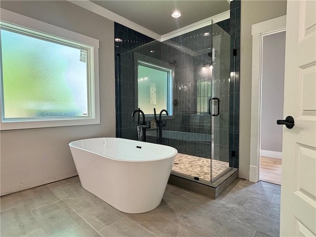full bathroom featuring a freestanding bath, a stall shower, and recessed lighting