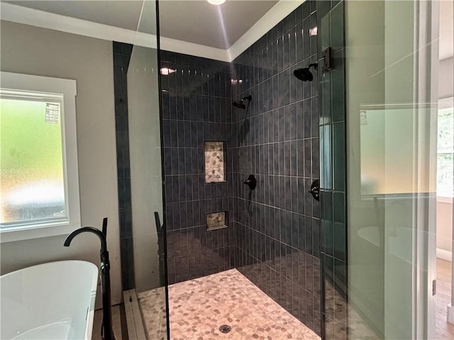 bathroom featuring a soaking tub and a shower stall