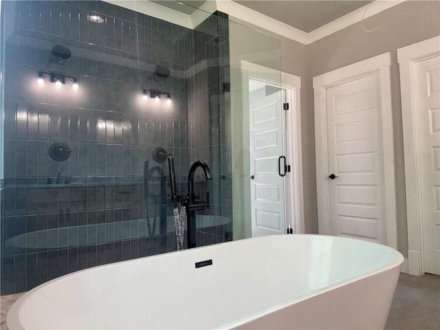 full bathroom featuring a tile shower, a freestanding bath, and tile patterned floors