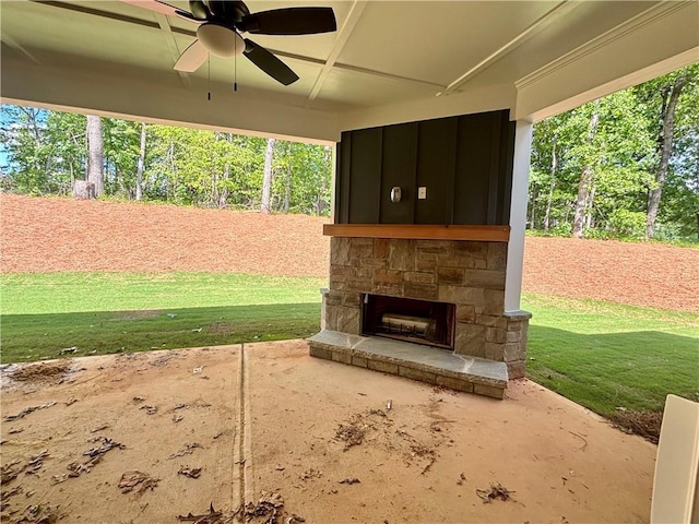 view of patio with ceiling fan and an outdoor stone fireplace