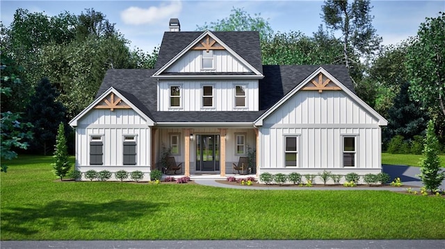 view of front of home with a front yard, a shingled roof, and board and batten siding