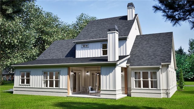 rear view of house featuring a lawn, a shingled roof, a chimney, and board and batten siding