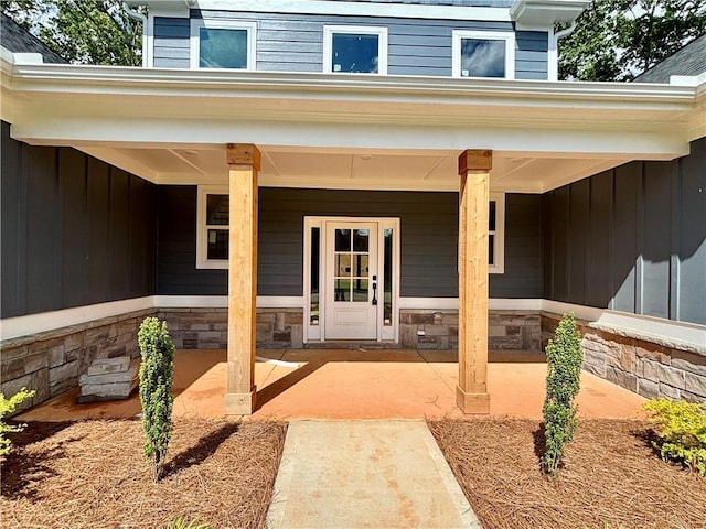 property entrance featuring stone siding