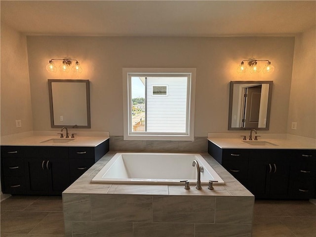 bathroom featuring vanity, tiled tub, and tile patterned floors