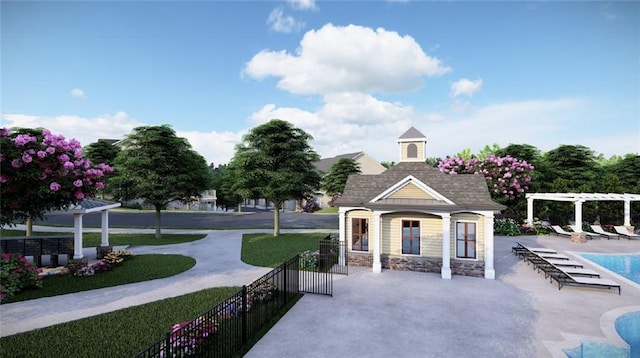 view of property's community with a pergola and a lawn