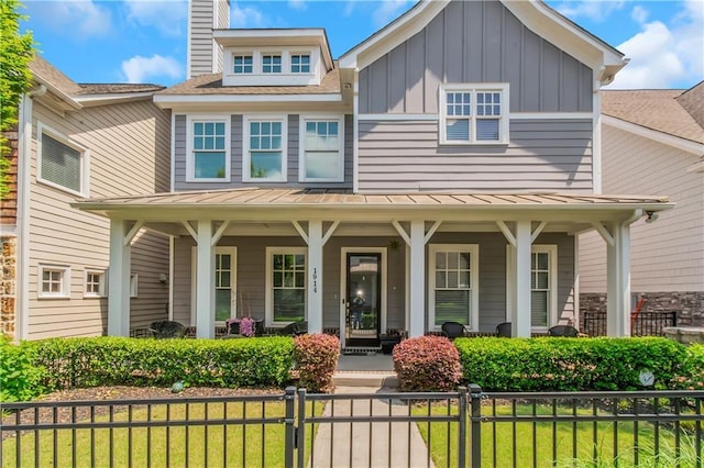 1914 Coal Pl, Atlanta, GA 30318 - view of front of property with a standing seam roof, covered porch, board and batten siding, and a front yard
