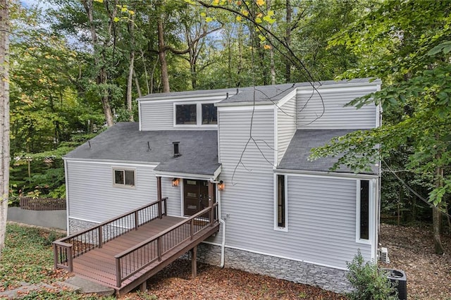 rear view of house featuring cooling unit