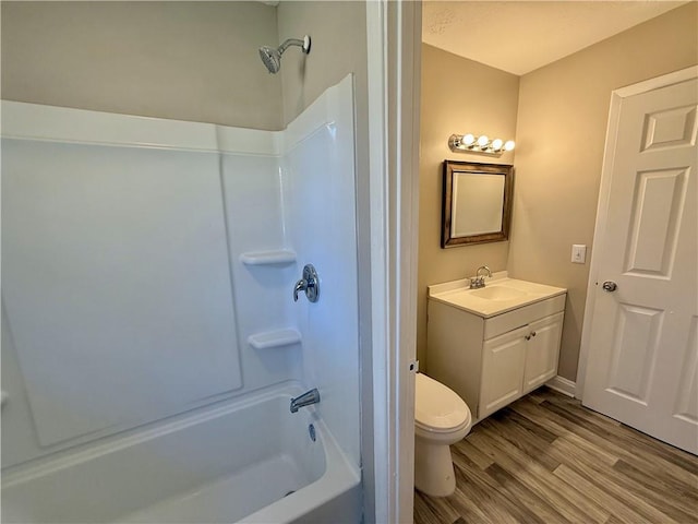 full bathroom with toilet, shower / washtub combination, wood finished floors, and vanity