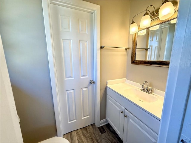 bathroom featuring wood finished floors and vanity