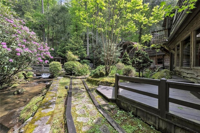 view of yard featuring a deck with water view