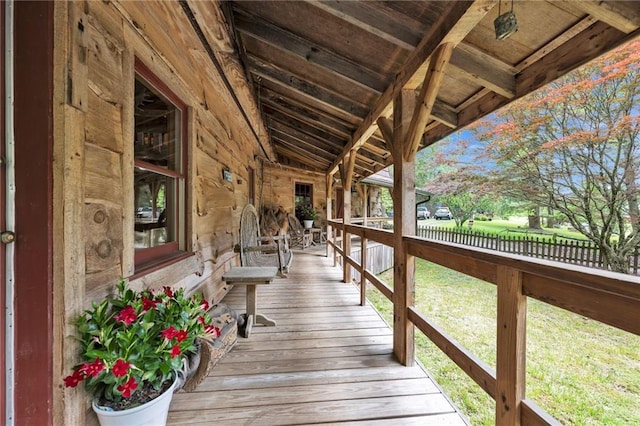 wooden deck with a lawn