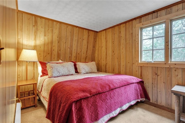 bedroom featuring light colored carpet, wooden walls, and ornamental molding