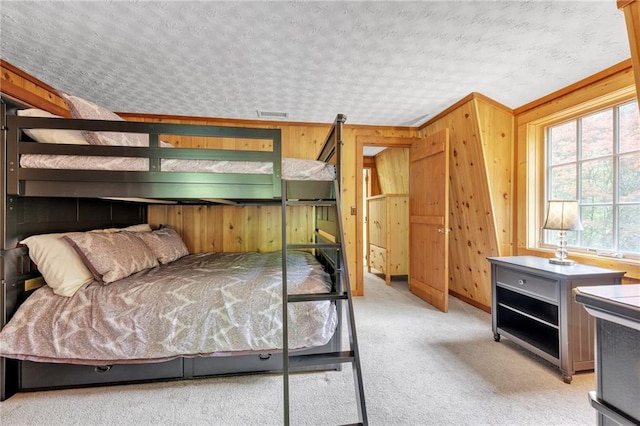 carpeted bedroom featuring a textured ceiling