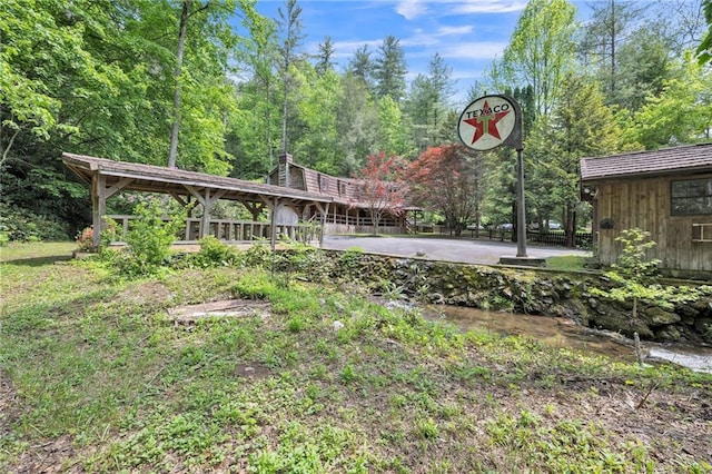 view of yard with basketball court and a water view