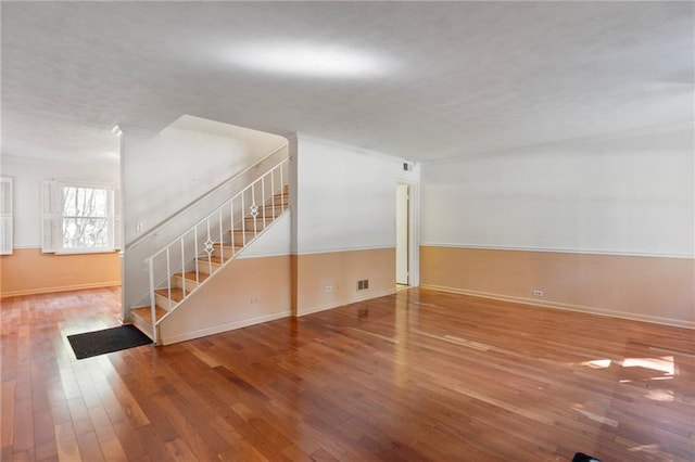 270 Lakemoore Dr NE Unit B, Atlanta, GA 30342 - unfurnished living room featuring stairs and hardwood / wood-style flooring