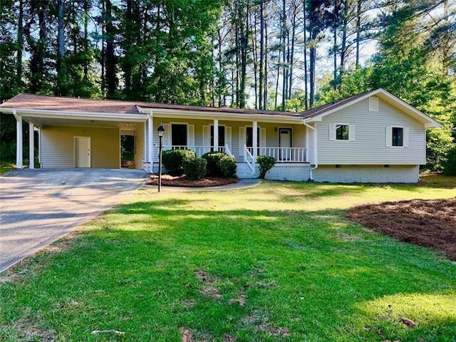 single story home with a carport, covered porch, and a front lawn