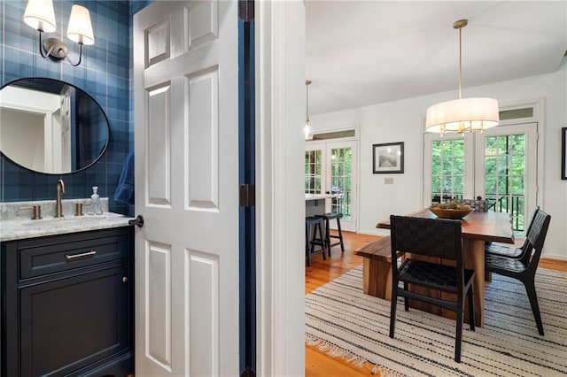 367 Windflower Dr, Big Canoe, GA 30143 - bathroom with healthy amount of natural light, french doors, wood finished floors, and vanity