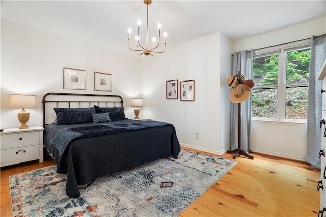 367 Windflower Dr, Big Canoe, GA 30143 - bedroom featuring a chandelier and light wood-style floors