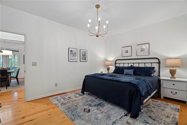 367 Windflower Dr, Big Canoe, GA 30143 - bedroom with a chandelier and light wood-type flooring