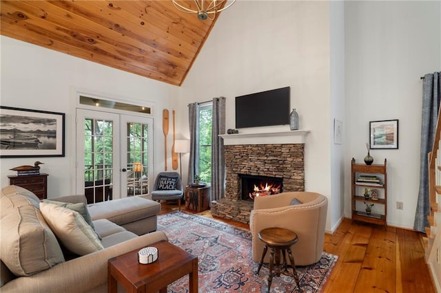367 Windflower Dr, Big Canoe, GA 30143 - living room featuring high vaulted ceiling, hardwood / wood-style flooring, healthy amount of natural light, french doors, and a fireplace