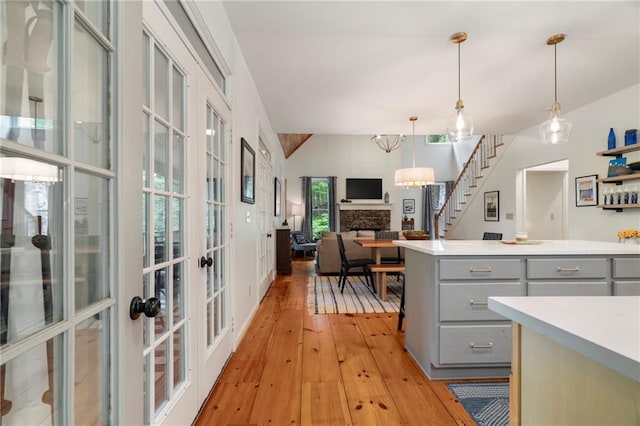 367 Windflower Dr, Big Canoe, GA 30143 - kitchen featuring gray cabinets, light wood-style floors, light countertops, french doors, and vaulted ceiling