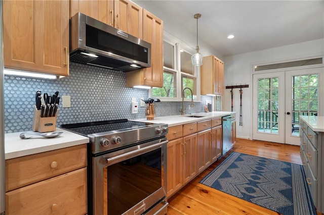 367 Windflower Dr, Big Canoe, GA 30143 - kitchen with stainless steel appliances, light countertops, decorative backsplash, light wood finished floors, and plenty of natural light