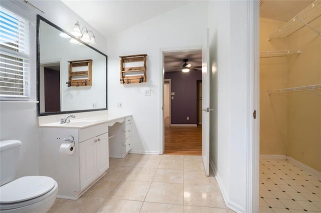 890 Oriole Ln SE, Marietta, GA 30067 - bathroom with lofted ceiling, toilet, ceiling fan, vanity, and tile patterned floors
