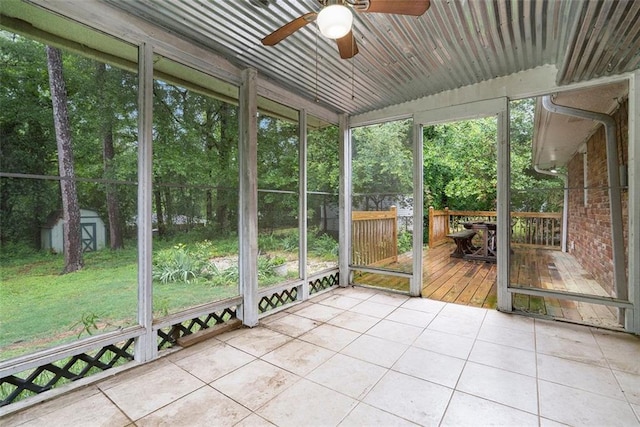 890 Oriole Ln SE, Marietta, GA 30067 - unfurnished sunroom with ceiling fan, plenty of natural light, and view of wooded area