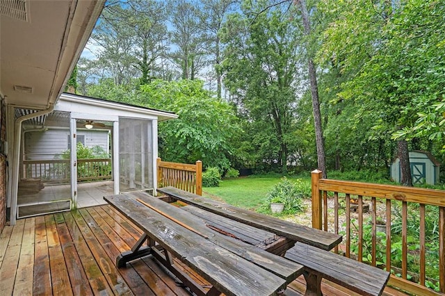 890 Oriole Ln SE, Marietta, GA 30067 - wooden deck with a sunroom, outdoor dining area, a storage unit, and an outdoor structure