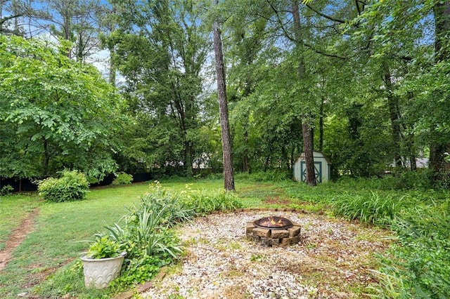 890 Oriole Ln SE, Marietta, GA 30067 - view of grassy yard with a fire pit, a storage shed, and an outdoor structure