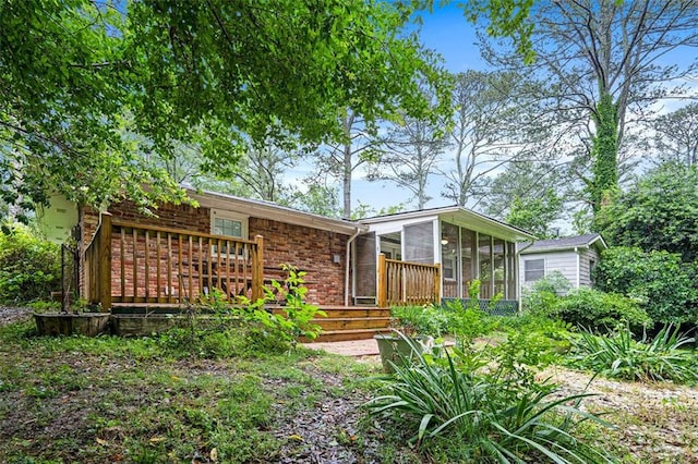 890 Oriole Ln SE, Marietta, GA 30067 - back of house featuring a sunroom, brick siding, and a wooden deck