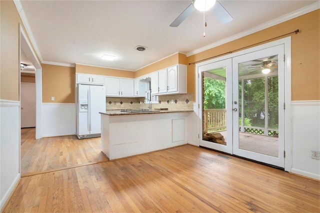 890 Oriole Ln SE, Marietta, GA 30067 - kitchen featuring white fridge with ice dispenser, a ceiling fan, a peninsula, light wood-style flooring, and white cabinets