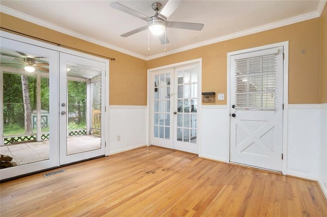 890 Oriole Ln SE, Marietta, GA 30067 - doorway to outside with french doors, a ceiling fan, light wood-style floors, a wainscoted wall, and crown molding