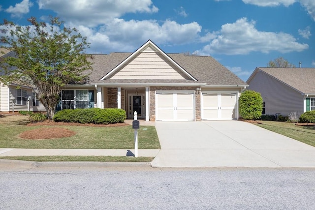 view of front of house featuring brick siding, an attached garage, driveway, and a front lawn