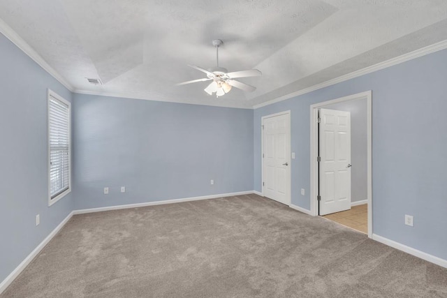 unfurnished bedroom with baseboards, ornamental molding, carpet, and a textured ceiling