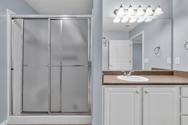 bathroom featuring vanity and a stall shower