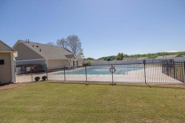 pool featuring a lawn, fence, and a patio