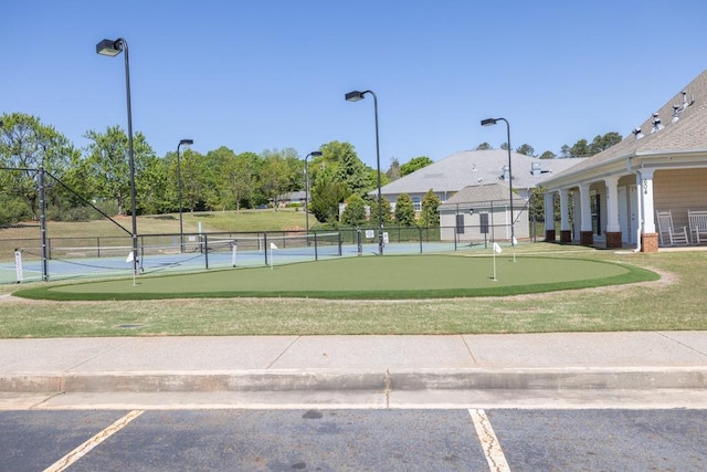 view of community with fence and a yard