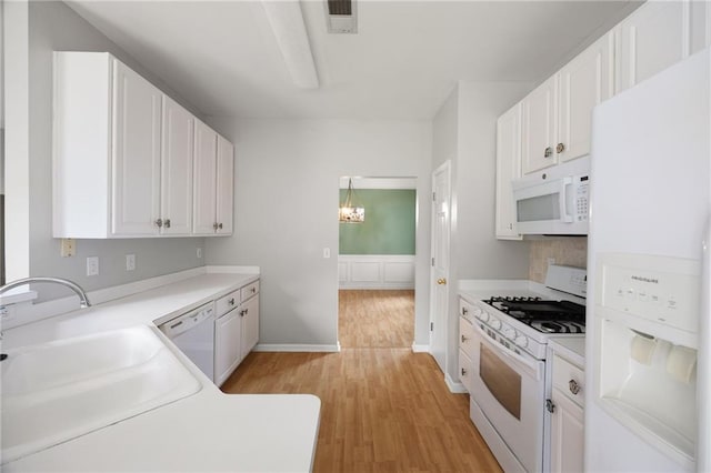 4801 Devonhurst Way, Powder Springs, GA 30127 - kitchen featuring white appliances, a sink, light wood-style flooring, and white cabinetry
