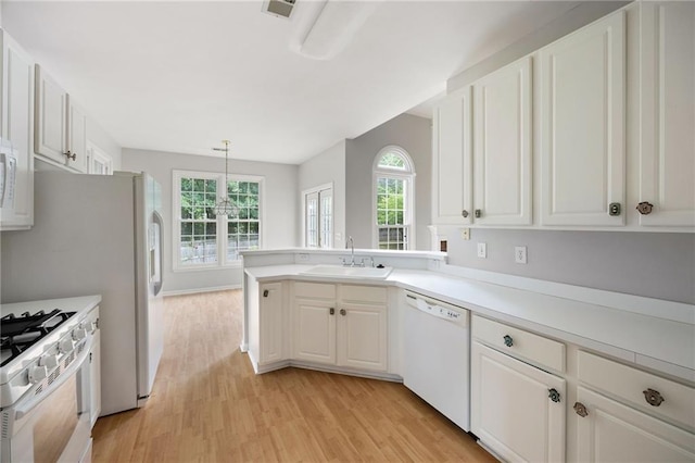 4801 Devonhurst Way, Powder Springs, GA 30127 - kitchen featuring white appliances, a sink, light wood-style floors, and healthy amount of natural light