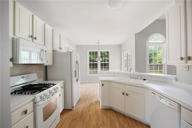 4801 Devonhurst Way, Powder Springs, GA 30127 - kitchen featuring white appliances, a sink, light wood-style flooring, light countertops, and backsplash