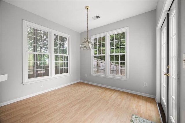 4801 Devonhurst Way, Powder Springs, GA 30127 - unfurnished dining area with plenty of natural light, baseboards, and light wood-style flooring