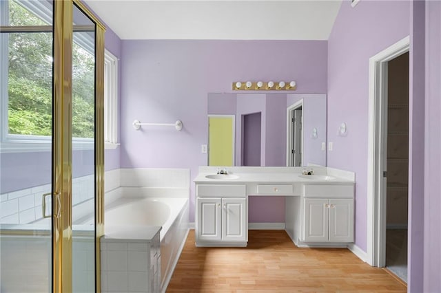 4801 Devonhurst Way, Powder Springs, GA 30127 - bathroom with plenty of natural light, double vanity, a bath, and wood finished floors
