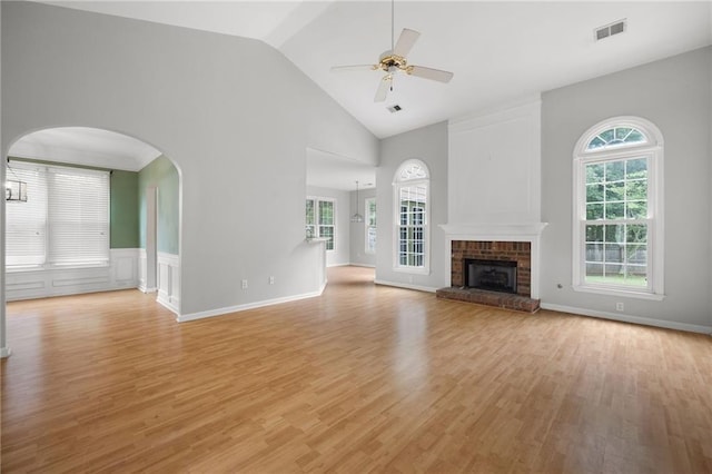 4801 Devonhurst Way, Powder Springs, GA 30127 - unfurnished living room featuring ceiling fan, light wood-type flooring, healthy amount of natural light, a brick fireplace, and high vaulted ceiling