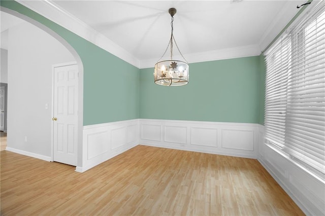 4801 Devonhurst Way, Powder Springs, GA 30127 - spare room featuring arched walkways, light wood-style flooring, wainscoting, a chandelier, and crown molding