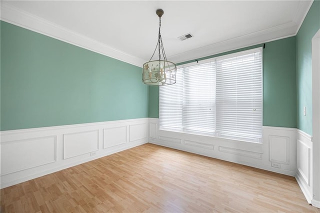 4801 Devonhurst Way, Powder Springs, GA 30127 - unfurnished room with crown molding, a chandelier, wainscoting, light wood finished floors, and a decorative wall