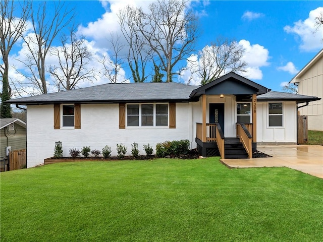 single story home with driveway, a front lawn, and board and batten siding