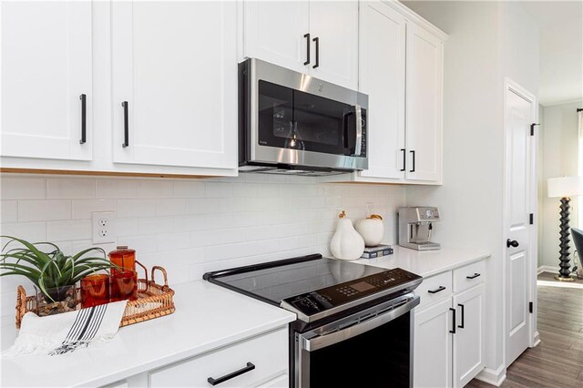 357 Skylar Ct SE, Atlanta, GA 30315 - kitchen with electric range oven, stainless steel microwave, light countertops, white cabinetry, and tasteful backsplash
